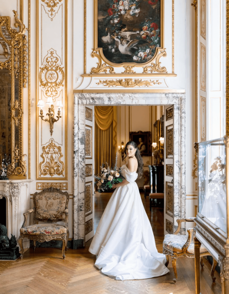 A bride standing infront a European neoclassical style entrance